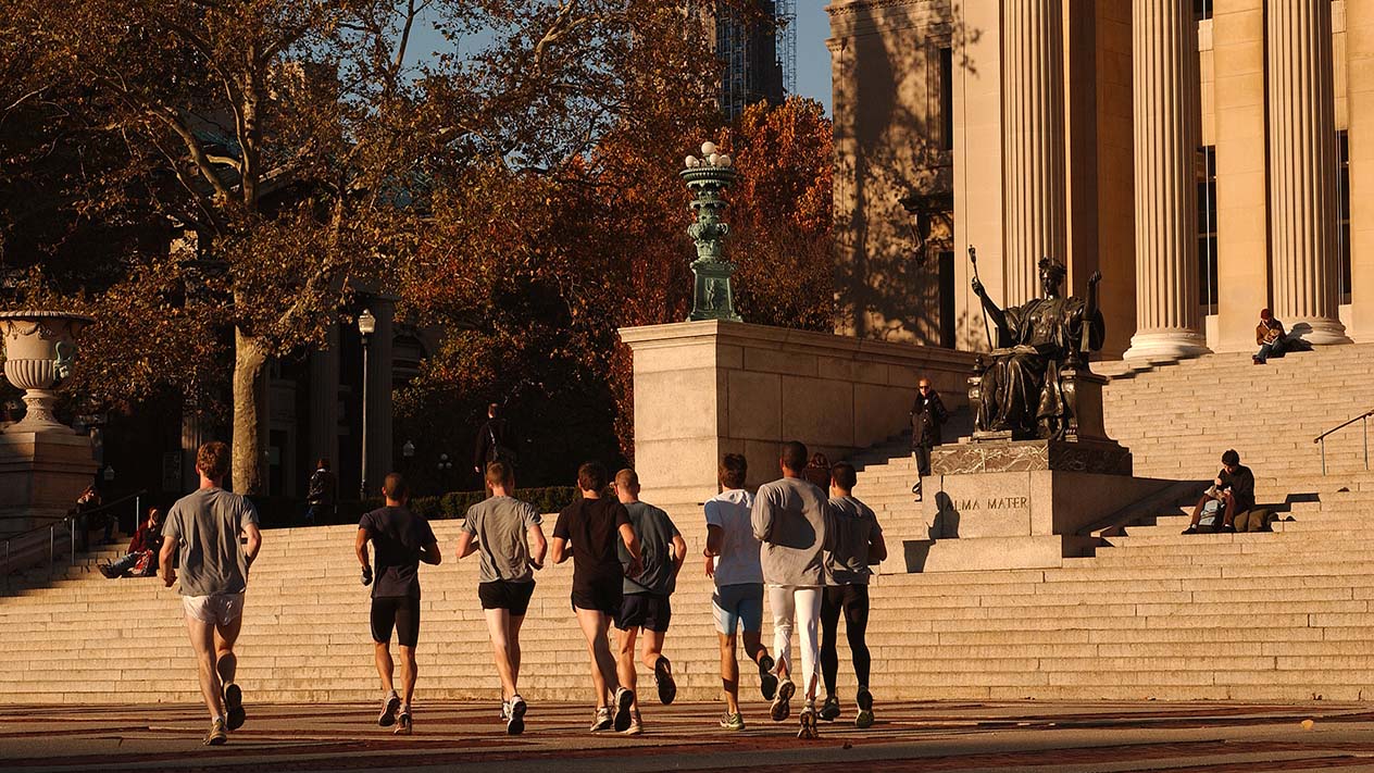 Joggers run on Columbia University's campus.