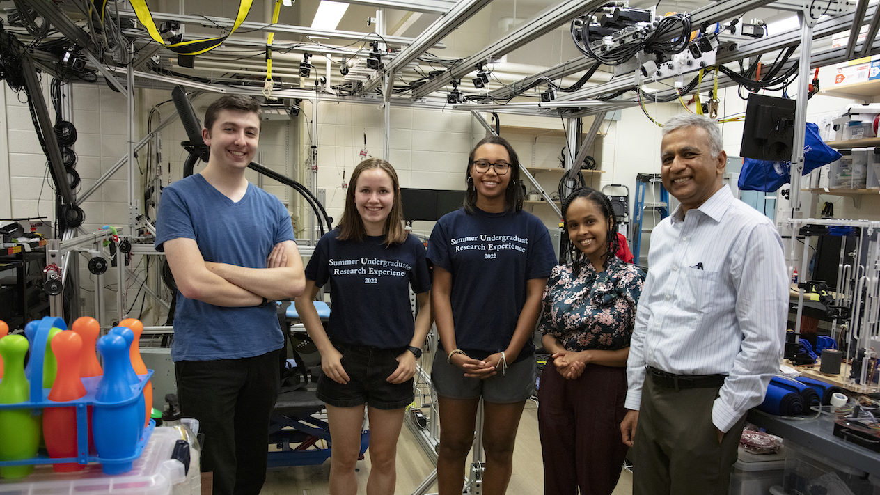 Summer Undergraduate Research Experience students smiling with a faculty advisor